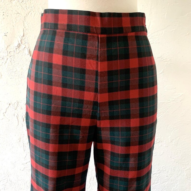 May include: Red and green plaid pants with a high waist.