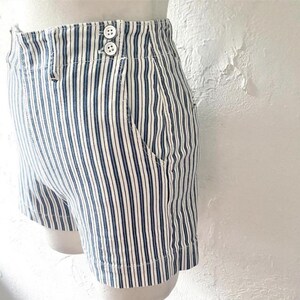 May include: White and blue striped high-waisted shorts with a button closure.