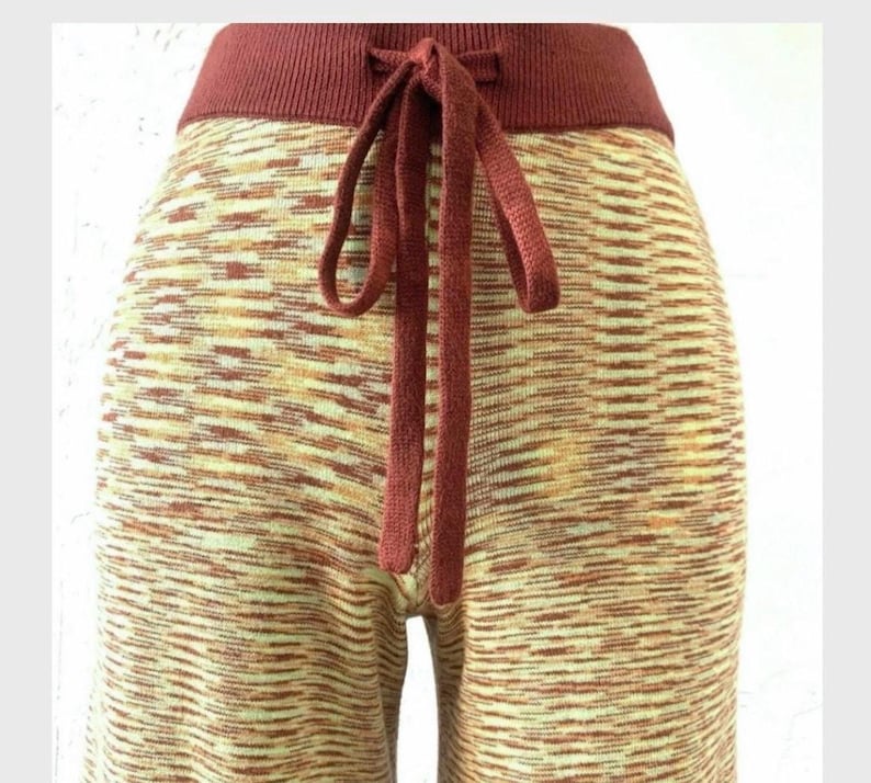 May include: Red and cream knit pants with a drawstring waist.