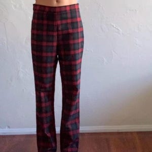 May include: Red and black plaid pants with a high waist and a straight leg fit.
