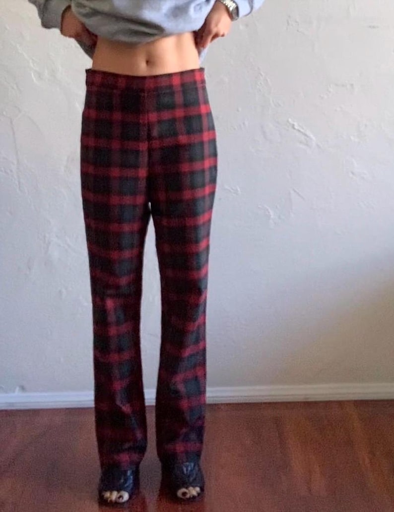 May include: Red and black plaid pants with a high waist and a straight leg fit.