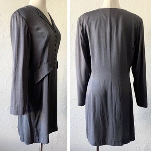 May include: A gray long-sleeved dress with a button-up front and a fitted silhouette.