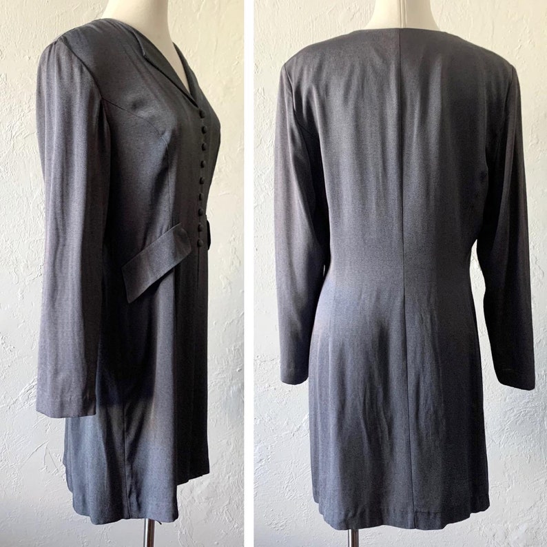 May include: A gray long-sleeved dress with a button-up front and a fitted silhouette.