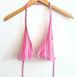 May include: Pink and white striped halter bikini top with adjustable straps.