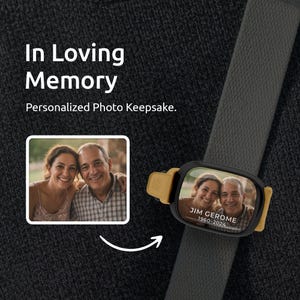 May include: A personalized photo keepsake with a picture of a couple. The keepsake is black and gold and is attached to a gray strap. The text "In Loving Memory" and "Personalized Photo Keepsake" are also visible.
