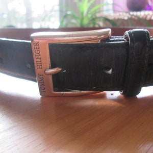 Vintage Tommy Hilfiger black textured leather belt with silver tone buckle. Made in USA size 38 unisex black belt. Fits 36 1/2-40 1/2&quot;