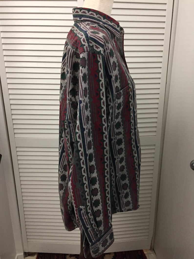 May include: A long-sleeved button-down shirt with a geometric pattern in shades of red, green, blue, and gray.