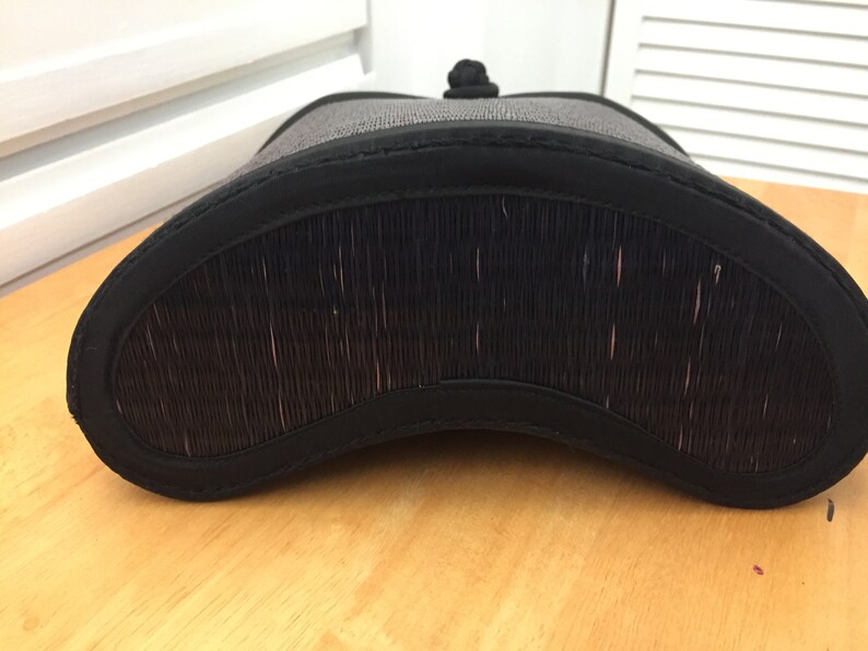 May include: Black woven basket with a black fabric lining and a black fabric handle.