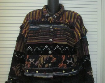 May include: A black and brown striped jacket with a faux fur trim. The jacket has a patchwork design with embroidered details and fringe accents.