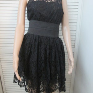 Black lace short lace dress with wide elastic waist and crinoline underskirt. Endless possibilities for this classic sleeveless  short dress