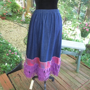 Denim semi full skirt with tie dye and fringed magenta hem. Elastic waist. Probably homemade Waist fits 31&quot; to 42&quot; Full denim tie dye hem.