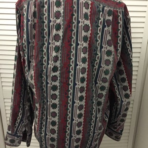 May include: A long-sleeved button-down shirt with a geometric pattern in shades of red, green, blue, and gray.