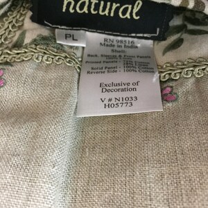 May include: A white tag with black text that reads "natural" and includes information about the fabric content and origin. The tag also includes the text "Exclusive of Decoration" and the numbers "V #N1033 H05773".