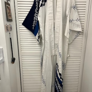 Handsewn cotton kimono Long white while w abstract blue pattern  with dramatic pattern at hem High quality cotton Appears never worn Unisex