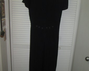 Vintage black jumpsuit with short sleeves and unique button details on front and back. Back zipper, Easy to shorten for current mod look.