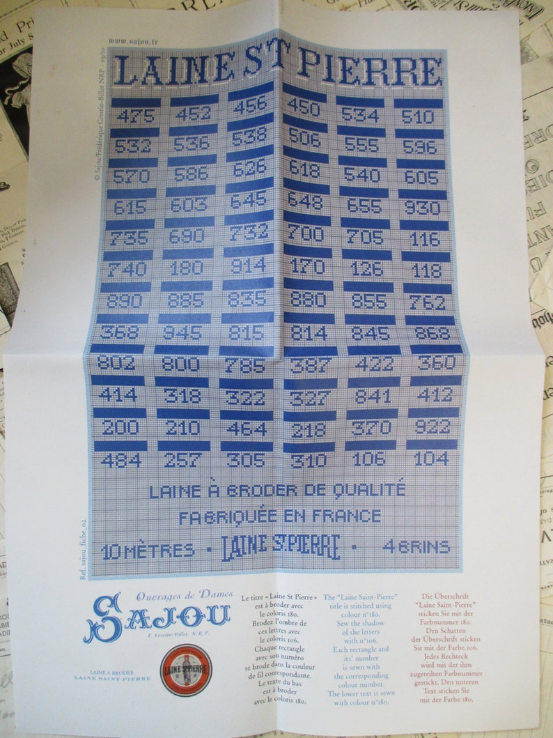 May include: A blue and white chart with the text "Laine St Pierre" and numbers. The chart is labeled "Laine &agrave; broder de qualit&eacute;" and "Fabriqu&eacute;e en France".