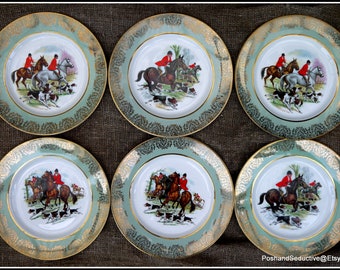 May include: Set of six decorative plates with a hunting scene. Each plate features a central image of riders on horseback, hounds, and a fox hunt. The plates have a light green border with a gold filigree design and a gold rim.