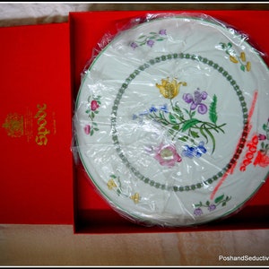May include: A white ceramic serving platter with a floral design in shades of pink, green, yellow, and blue. The platter is in a red box with the word "Spode" printed in gold lettering.
