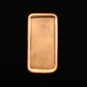 May include: A rectangular copper-colored metal plaque with a smooth, slightly textured surface.