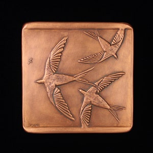 May include: A copper plaque with three stylized birds in flight, the plaque is signed "Voeppel" in the lower left corner.