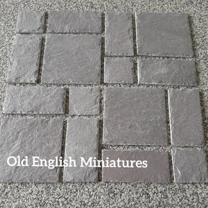 May include: A collection of gray slate tiles in various sizes, arranged in a grid pattern. The tiles have a rough, textured surface. The text "Old English Miniatures" is printed in white on the bottom of the image.