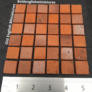 May include: A set of 36 small, red, square tiles, measuring approximately 1 inch by 1 inch. The tiles are arranged in a grid pattern and are made of a rough, textured material. #oldenglishminiatures