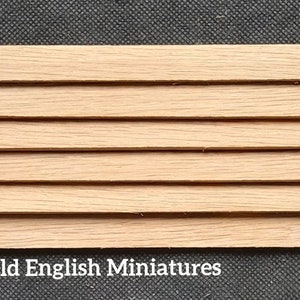 May include: A set of six wooden strips, each with a natural wood finish. The strips are arranged horizontally and are slightly offset from each other. The strips are approximately 1/4 inch thick and 1/2 inch wide.  Old English Miniatures.