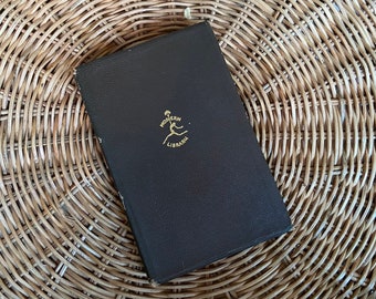 May include: A black hardcover book with gold lettering on the front cover. The book is titled "Modern Library" and features a stylized image of a person running.