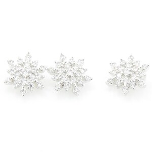 May include: A pair of silver snowflake earrings with clear cubic zirconia stones.