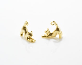 May include: Two gold-colored cat charms, each with a loop at the top for attaching to jewelry or other crafts. The cats are in a playful pose, with one cat stretching and the other cat sitting up.