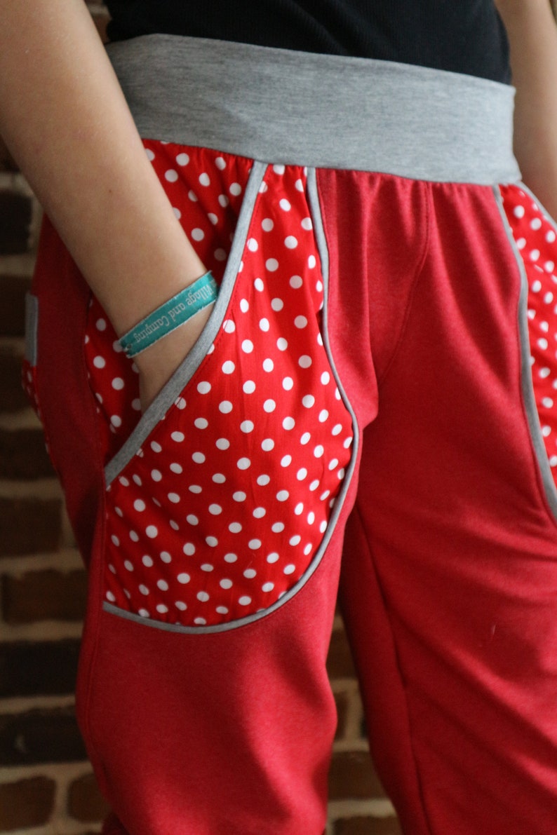 May include: Red sweatpants with a white polka dot pocket detail and a gray waistband.