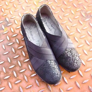 A pair of black suede wedges with floral wedge heels and damask print shoes detailing, crafted as eco leather flats in UK size 5 shoes. These arch support shoes offer comfort for daily wear, styled as casual black flats or editorial loafers. Designed as a walking comfort shoe, they feature soft sole wedges and reflect handmade footwear values. A perfect slow fashion gift, ideal for collectors of vintage style shoes.