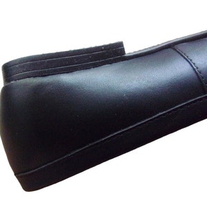 A pair of Vintage Loafers styled as Black Leather Loafers with a bow detail, these 1980s Leather Flats are timeless Bow Detail Loafers made from Soft Leather Shoes. Perfect as Retro Work Shoes, Minimalist Loafers, or Office Leather Flats, they channel Preppy Style Shoes and Quiet Luxury. Designed as Gender Neutral Shoes, they reflect Archive Fashion values and sustainable elegance in classic Leather Slip Ons.