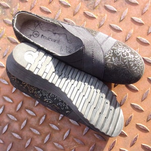 A pair of black suede wedges with floral wedge heels and damask print shoes detailing, crafted as eco leather flats in UK size 5 shoes. These arch support shoes offer comfort for daily wear, styled as casual black flats or editorial loafers. Designed as a walking comfort shoe, they feature soft sole wedges and reflect handmade footwear values. A perfect slow fashion gift, ideal for collectors of vintage style shoes.