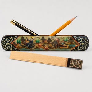 Handcrafted vintage Persian miniature pen holder displayed in a light grey studio with a pen and pencil, featuring hand-painted artwork, marquetry detailing, and elegant boho desk decor.
