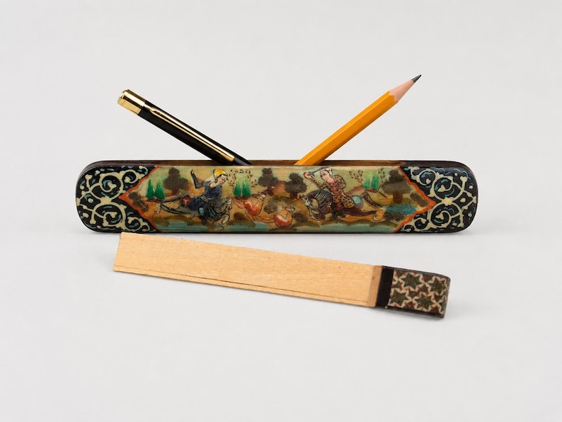 Handcrafted vintage Persian miniature pen holder displayed in a light grey studio with a pen and pencil, featuring hand-painted artwork, marquetry detailing, and elegant boho desk decor.