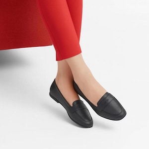 A pair of Vintage Loafers styled as Black Leather Loafers with a bow detail, these 1980s Leather Flats are timeless Bow Detail Loafers made from Soft Leather Shoes. Perfect as Retro Work Shoes, Minimalist Loafers, or Office Leather Flats, they channel Preppy Style Shoes and Quiet Luxury. Designed as Gender Neutral Shoes, they reflect Archive Fashion values and sustainable elegance in classic Leather Slip Ons.
