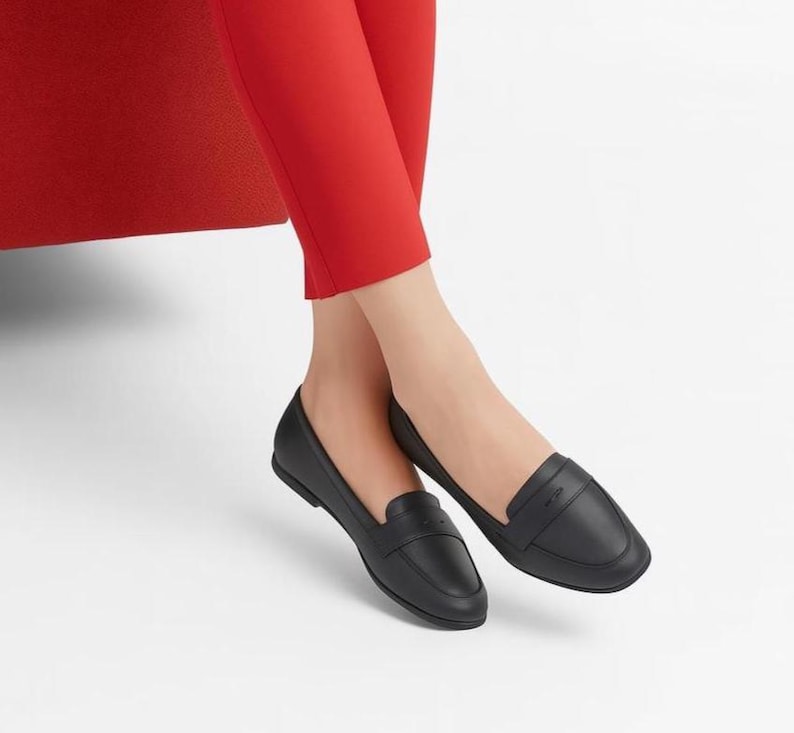A pair of Vintage Loafers styled as Black Leather Loafers with a bow detail, these 1980s Leather Flats are timeless Bow Detail Loafers made from Soft Leather Shoes. Perfect as Retro Work Shoes, Minimalist Loafers, or Office Leather Flats, they channel Preppy Style Shoes and Quiet Luxury. Designed as Gender Neutral Shoes, they reflect Archive Fashion values and sustainable elegance in classic Leather Slip Ons.