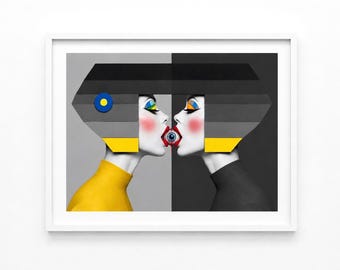 May include: A framed art print featuring two stylized figures facing each other in profile. One figure wears a yellow top, the other a black top. They have geometric gray hair, colorful eye makeup, and red lips, with a single blue eye held between their mouths.