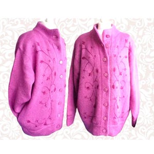 Lilac mohair oversized cardigan with textured knit and buttons worn with a black skirt.