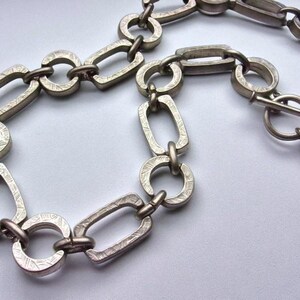 Close-up of a Brutalist Necklace featuring a Steel Link Chain and Geometric Choker design. This Industrial Style piece showcases Sculptural Steel with a bold Architectural Look, ideal for Urban Jewelry UK collectors. A Statement Chain and Unisex Necklace, it’s a Sustainable Gift and perfect Gift for Him. Inspired by MCM Revival, this Bold Steel Piece blends raw texture with timeless edge.