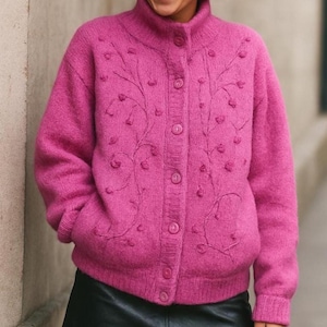 Lilac mohair oversized cardigan with textured knit and buttons worn with a black skirt.