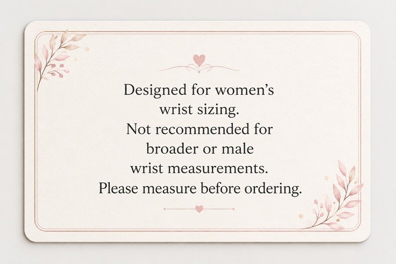 A rectangular card with rounded corners featuring a pale cream background and a thin pink border. Delicate pink leaf illustrations decorate the top-left and bottom-right corners. The text reads: Designed for women's wrist sizing. Not recommended for broader or male wrist measurements. Please measure before ordering.