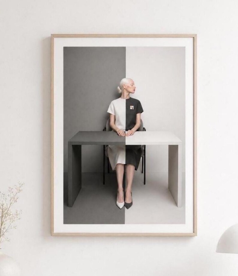 Modern monochrome portrait wall art mockup displayed against a dark moody wall, elegant framed fashion print with realistic glass reflection, decorative vase with white dried leaves, luxury minimalist living room styling.