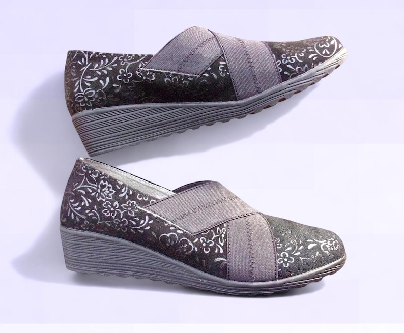 A pair of black suede wedges with floral wedge heels and damask print shoes detailing, crafted as eco leather flats in UK size 5 shoes. These arch support shoes offer comfort for daily wear, styled as casual black flats or editorial loafers. Designed as a walking comfort shoe, they feature soft sole wedges and reflect handmade footwear values. A perfect slow fashion gift, ideal for collectors of vintage style shoes.