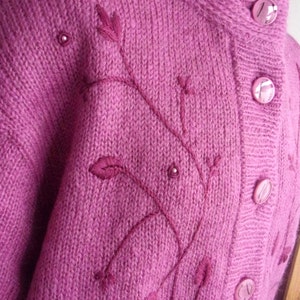 Lilac mohair oversized cardigan with textured knit and buttons worn with a black skirt.