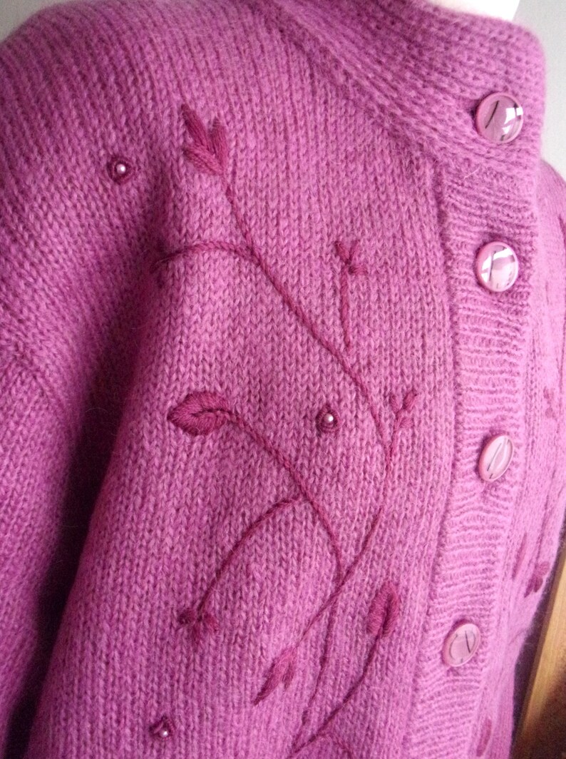 Lilac mohair oversized cardigan with textured knit and buttons worn with a black skirt.