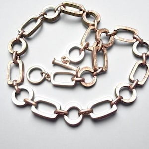 Close-up of a Brutalist Necklace featuring a Steel Link Chain and Geometric Choker design. This Industrial Style piece showcases Sculptural Steel with a bold Architectural Look, ideal for Urban Jewelry UK collectors. A Statement Chain and Unisex Necklace, it’s a Sustainable Gift and perfect Gift for Him. Inspired by MCM Revival, this Bold Steel Piece blends raw texture with timeless edge.