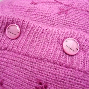 Lilac mohair oversized cardigan with textured knit and buttons worn with a black skirt.