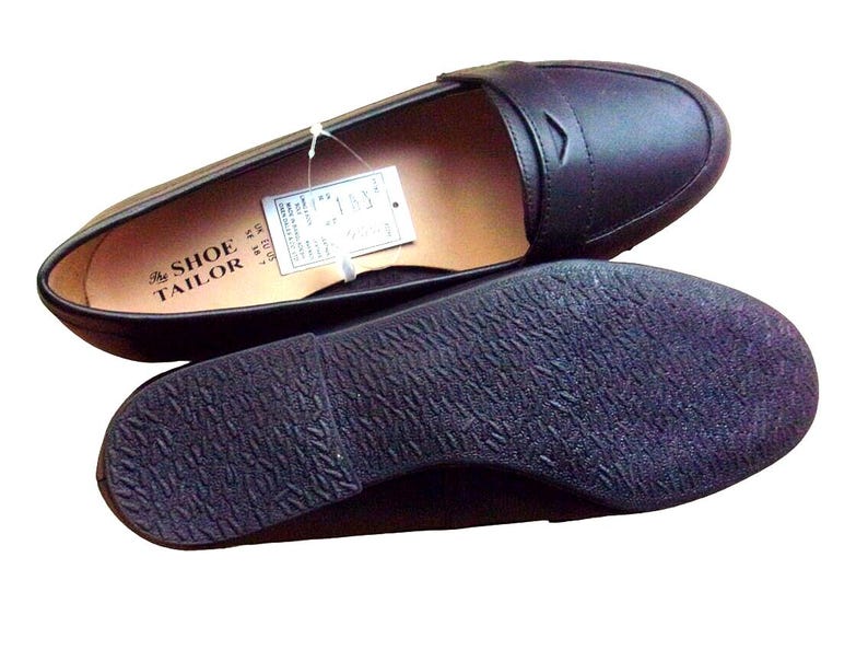 A pair of Vintage Loafers styled as Black Leather Loafers with a bow detail, these 1980s Leather Flats are timeless Bow Detail Loafers made from Soft Leather Shoes. Perfect as Retro Work Shoes, Minimalist Loafers, or Office Leather Flats, they channel Preppy Style Shoes and Quiet Luxury. Designed as Gender Neutral Shoes, they reflect Archive Fashion values and sustainable elegance in classic Leather Slip Ons.